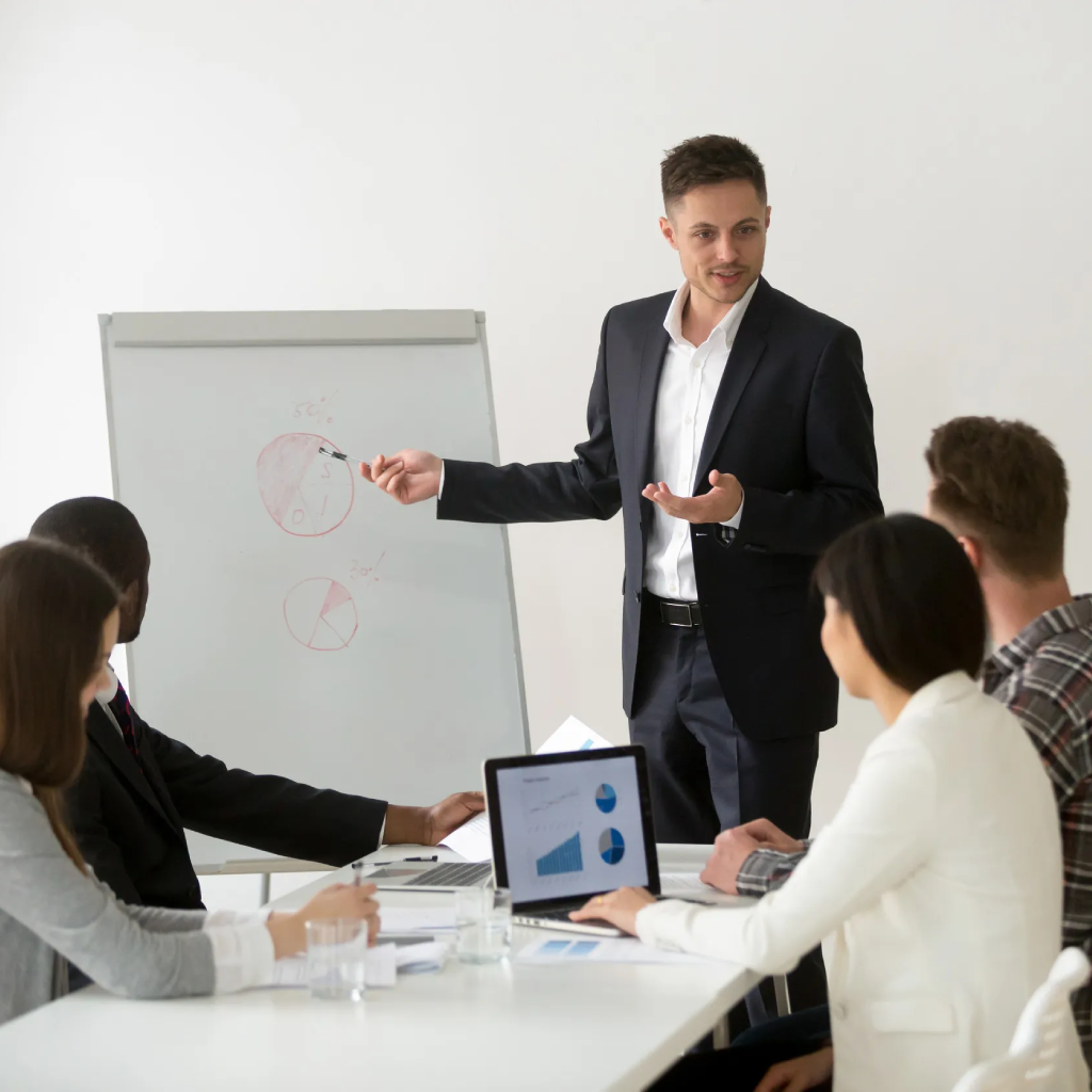 Successful businessman boss presenting new project to employees (1) Successful businessman boss presenting new project to employees